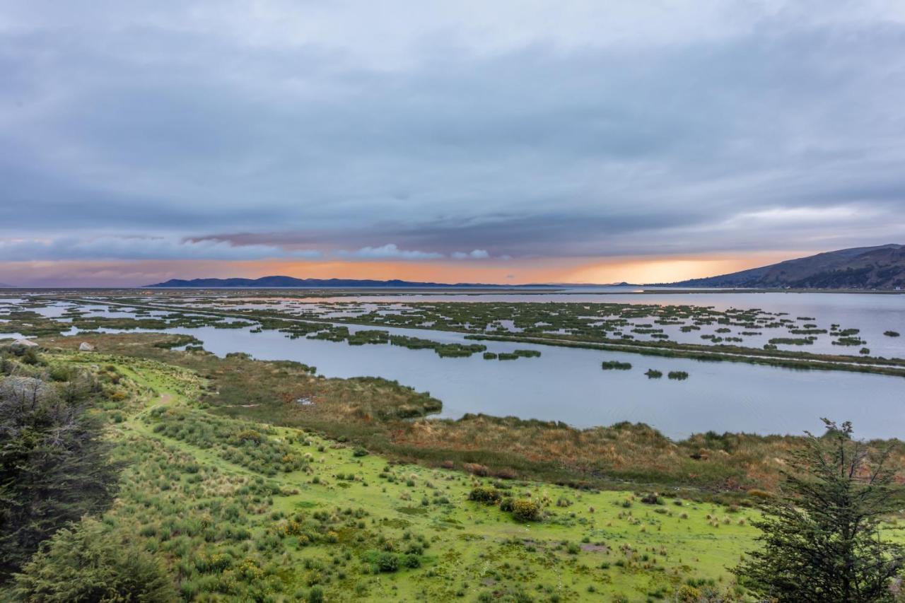 Ghl Hotel Lago Titicaca Puno Exterior photo Sunset over the bay